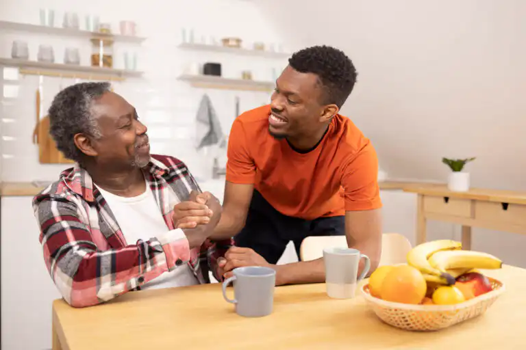A man shakes hands with his father as he helps him navigate life with chronic illness.