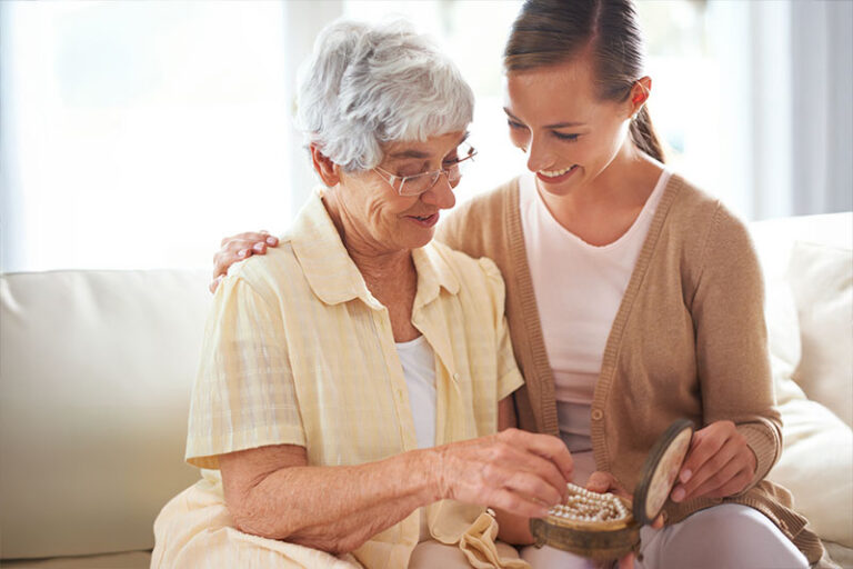 A woman uses dementia redirection techniques with her aging mother.
